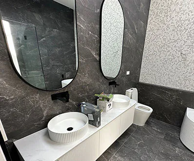 A new bathroom renovation with mosaic tile details, featuring a modern design and elegant fixtures